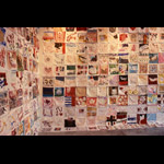 Installation view, corner of south and east wall of gallery covered in small textile squares