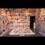 Installation view, gallery walls and floor covered in small textile squares