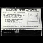 Image of development permit with added text 'THE URGENCY OF HIS HANDS SILENCES HER'